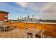 Enjoy the scenic city views from this cozy rooftop terrace with comfortable seating and wood accents at 3180 Mathieson Ne Dr # 806, Atlanta, GA 30305