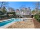 Expansive backyard featuring a large swimming pool, patio area, and lush landscaping, ideal for outdoor living and entertaining at 325 Wynland Trce, Sandy Springs, GA 30350