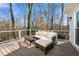 Relax on the deck with comfortable seating and enjoy the wooded views from the home's outdoor space at 325 Wynland Trce, Sandy Springs, GA 30350