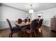 Elegant dining room with modern light fixture, crown molding, and access to living area at 325 Wynland Trce, Sandy Springs, GA 30350