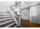 Bright foyer boasts hardwood floors, staircase with wood rails, and neutral paint that creates a welcoming atmosphere at 325 Wynland Trce, Sandy Springs, GA 30350