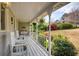 Covered front porch with white railings and a swing, offering a relaxing outdoor space at 325 Wynland Trce, Sandy Springs, GA 30350