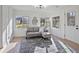 Inviting living room featuring a comfortable sofa, stylish area rug, and plenty of natural light at 4013 Oglesby Rd, Powder Springs, GA 30127