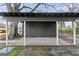 A gray shed in the backyard with white supports and a concrete pad at 4013 Oglesby Rd, Powder Springs, GA 30127