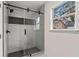 Modern bathroom featuring a glass-enclosed shower with tile surround and a window at 819 Humphries St, Atlanta, GA 30310