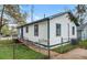 Charming white home featuring blue trim, a fenced yard, and a convenient walkway at 819 Humphries St, Atlanta, GA 30310