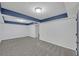 Large basement room with gray carpet, white walls, and blue accent trim at 137 Creekview Dr, Woodstock, GA 30188