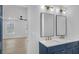 Dual vanity bathroom with modern fixtures, mirrors, and a bright, open view into the bedroom at 137 Creekview Dr, Woodstock, GA 30188