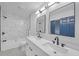 Modern bathroom with double sink vanity, white cabinets, and marble-style tiled shower at 137 Creekview Dr, Woodstock, GA 30188