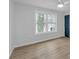 Bedroom with hardwood floors, large windows, and a modern ceiling fan at 137 Creekview Dr, Woodstock, GA 30188