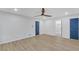Spacious bedroom with wood floors, modern fan, and blue-painted doors at 137 Creekview Dr, Woodstock, GA 30188