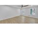Bright bedroom featuring hardwood floors, a ceiling fan, and two large windows at 137 Creekview Dr, Woodstock, GA 30188