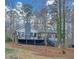 View of rear exterior of the home showcasing an elevated deck at 137 Creekview Dr, Woodstock, GA 30188