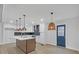 Bright, modern kitchen with a stylish island, pendant lighting, white cabinets, and stainless steel appliances at 137 Creekview Dr, Woodstock, GA 30188