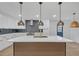 Modern kitchen featuring a large island with stylish pendant lighting at 137 Creekview Dr, Woodstock, GA 30188