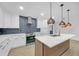 Modern kitchen with marble backsplash, white cabinets, and center island at 137 Creekview Dr, Woodstock, GA 30188