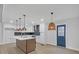Bright, modern kitchen with a stylish island, pendant lighting, white cabinets, and stainless steel appliances at 137 Creekview Dr, Woodstock, GA 30188
