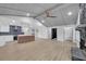 Open-concept living space with kitchen island, black fireplace, and vaulted ceilings, perfect for entertaining at 137 Creekview Dr, Woodstock, GA 30188