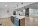 Open concept layout featuring a modern kitchen with an island bar overlooking a cozy living room with a fireplace at 137 Creekview Dr, Woodstock, GA 30188
