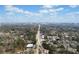 Aerial view featuring a road leading to the cityscape in the background, nestled within a lush, green landscape of trees and buildings at 2712 Stargazer Ter, Smyrna, GA 30080