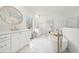 Bright bathroom featuring marble floors, double vanities, soaking tub, and gold fixtures at 2712 Stargazer Ter, Smyrna, GA 30080