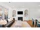 Cozy living room featuring a fireplace, decorative shelving, and large windows at 2712 Stargazer Ter, Smyrna, GA 30080