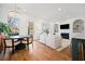 Open concept living and dining area with modern light fixture and fireplace at 2712 Stargazer Ter, Smyrna, GA 30080