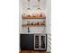 The mini-bar features a black cabinets, shelves of liquor, and built-in wine cooler at 2712 Stargazer Ter, Smyrna, GA 30080