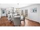 Dining room featuring a modern chandelier and adjacent kitchen with stainless steel appliances at 4240 Parnell Rd, Marietta, GA 30062