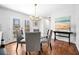 Bright dining room featuring hardwood floors, modern lighting and a glass table near the sliding glass door at 4240 Parnell Rd, Marietta, GA 30062