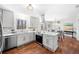 Well-lit kitchen with hardwood floors, stainless steel appliances, and quartz countertops at 4240 Parnell Rd, Marietta, GA 30062