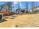 Expansive backyard with a fire pit, mature trees, and a well-maintained lawn at 4350 White Surrey Nw Dr, Kennesaw, GA 30144