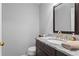 Well-lit powder room featuring granite counters and a decorative mirror at 4350 White Surrey Nw Dr, Kennesaw, GA 30144