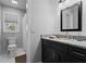 Stylish bathroom with granite counters, black vanity, and updated fixtures at 4350 White Surrey Nw Dr, Kennesaw, GA 30144