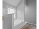 Bright bathroom featuring a soaking tub, glass-enclosed shower, and modern fixtures at 4350 White Surrey Nw Dr, Kennesaw, GA 30144