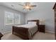 Comfortable bedroom with natural light, a plush bed, and side table with a lamp at 4350 White Surrey Nw Dr, Kennesaw, GA 30144