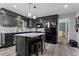 Stylish kitchen featuring dark cabinetry, an island with seating, and stainless steel appliances at 4350 White Surrey Nw Dr, Kennesaw, GA 30144