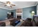 Comfortable living room with ceiling fan, fireplace and gray wood floors at 4350 White Surrey Nw Dr, Kennesaw, GA 30144