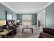 Comfortable living room with gray wood floors, blue walls and a front view window at 4350 White Surrey Nw Dr, Kennesaw, GA 30144