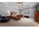 Spacious main bedroom featuring a ceiling fan, carpeted floors and well lit windows at 4350 White Surrey Nw Dr, Kennesaw, GA 30144