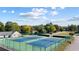 View of the community tennis courts in front of a clubhouse with a beautiful blue sky at 4350 White Surrey Nw Dr, Kennesaw, GA 30144