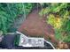 Aerial view of landscaped backyard with patio, grill, and surrounding woods at 6090 River Chase Cir, Atlanta, GA 30328