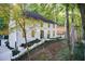 Two-story home with manicured landscaping, black trim, and a driveway to the left at 6090 River Chase Cir, Atlanta, GA 30328