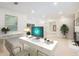 Well-lit home office offers a spacious white desk, neutral decor, and a view into the adjoining living room at 6090 River Chase Cir, Atlanta, GA 30328