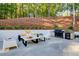 Outdoor living space features a grill, seating area, outdoor kitchen, and landscaped yard at 6090 River Chase Cir, Atlanta, GA 30328