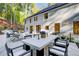 Outdoor patio with dining table, chairs, lounge furniture, and a view of the landscaped yard at 6090 River Chase Cir, Atlanta, GA 30328