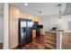 Modern kitchen with stainless steel appliances, light wood cabinets, and black countertops at 3324 Peachtree Ne Rd # 1718, Atlanta, GA 30326