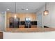 Updated kitchen featuring granite countertops, stainless appliances, and stylish pendant lighting at 3324 Peachtree Ne Rd # 1718, Atlanta, GA 30326