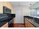 Well-appointed kitchen with black appliances, subway tile backsplash, and wood cabinets at 3324 Peachtree Ne Rd # 1718, Atlanta, GA 30326