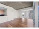 Spacious living room featuring hardwood floors, concrete ceiling, and lots of natural light from large windows at 3324 Peachtree Ne Rd # 1718, Atlanta, GA 30326